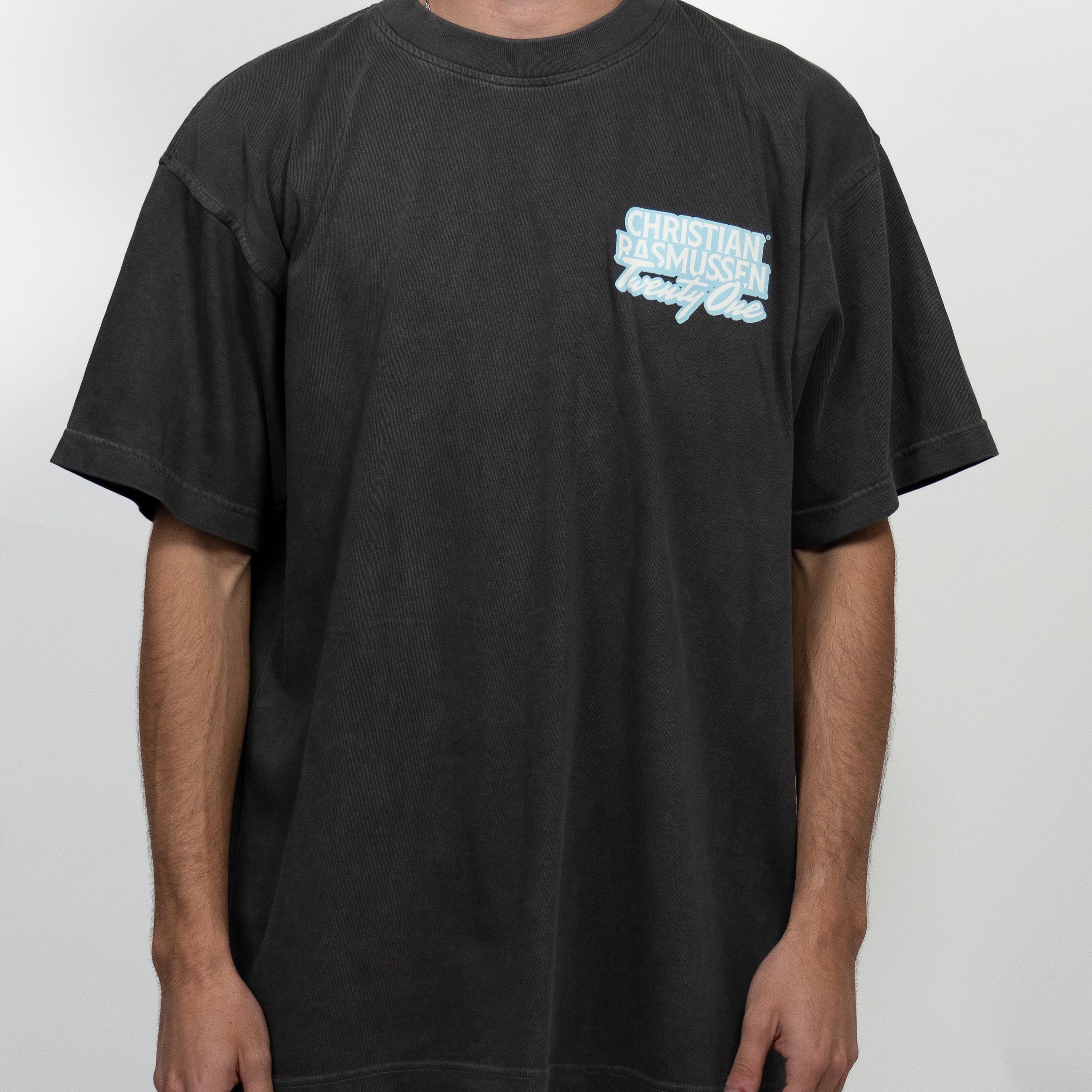 Person wearing a black t-shirt with a logo on a white background