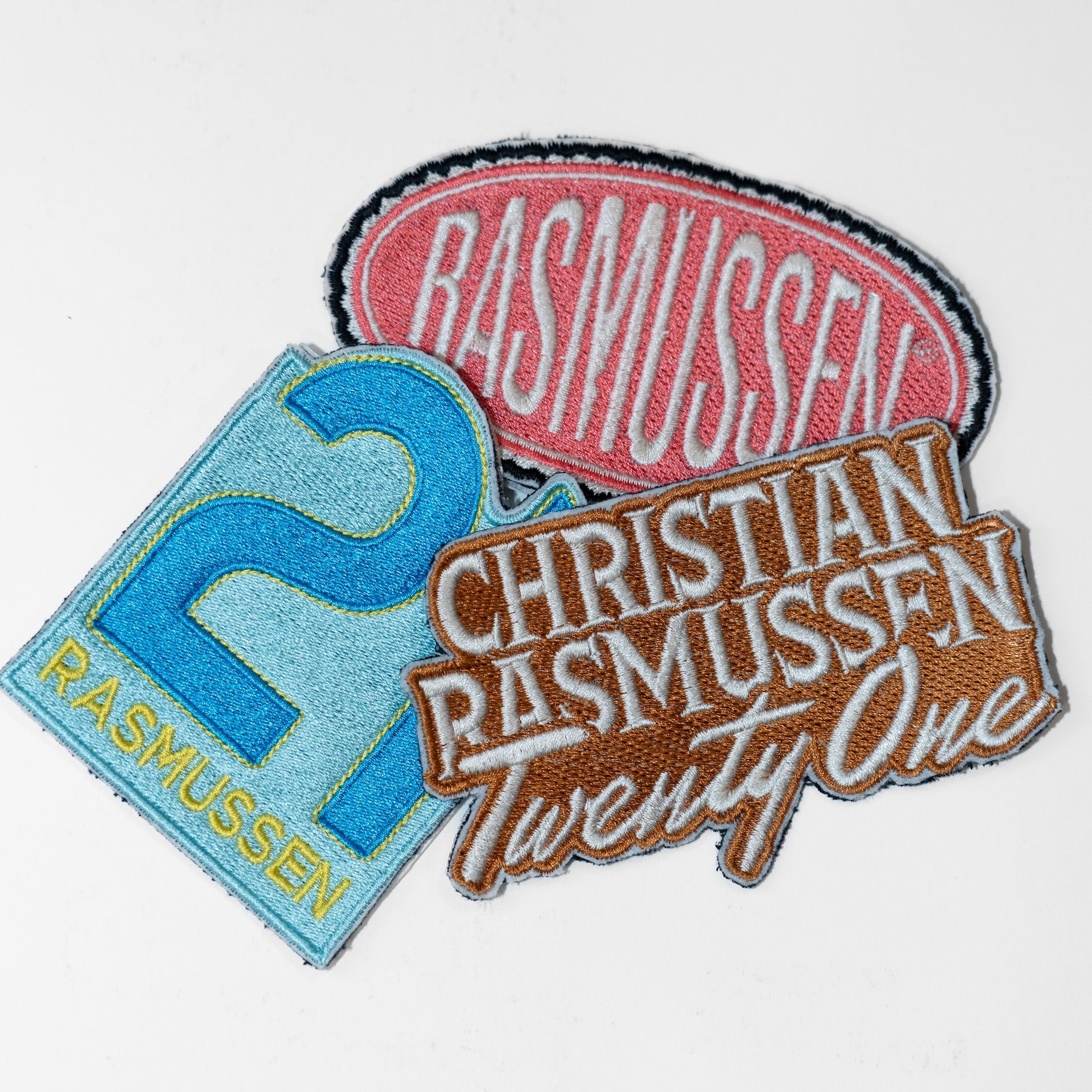 Three embroidered patches with text and numbers on a white background