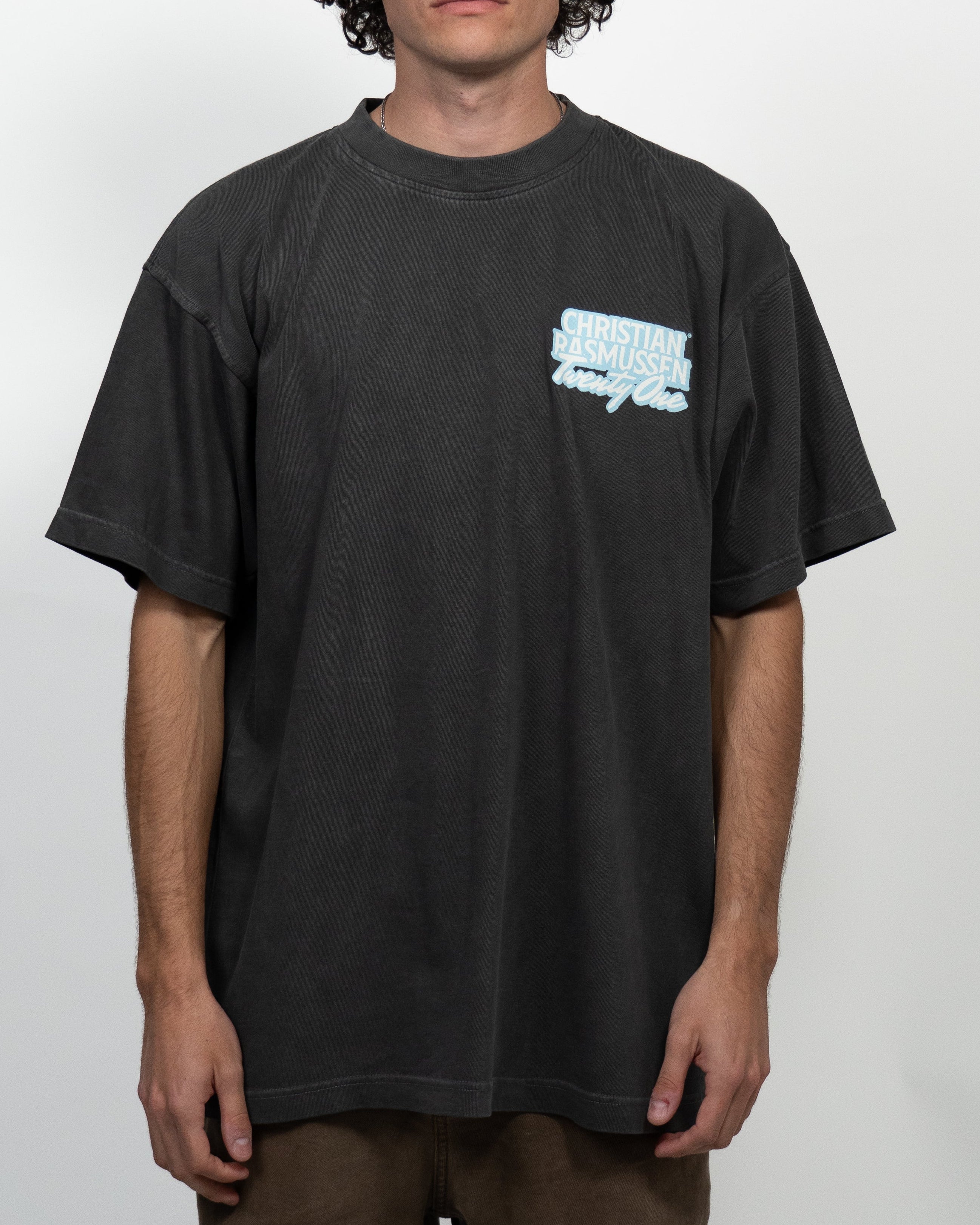 Person wearing a black t-shirt with a logo on a white background