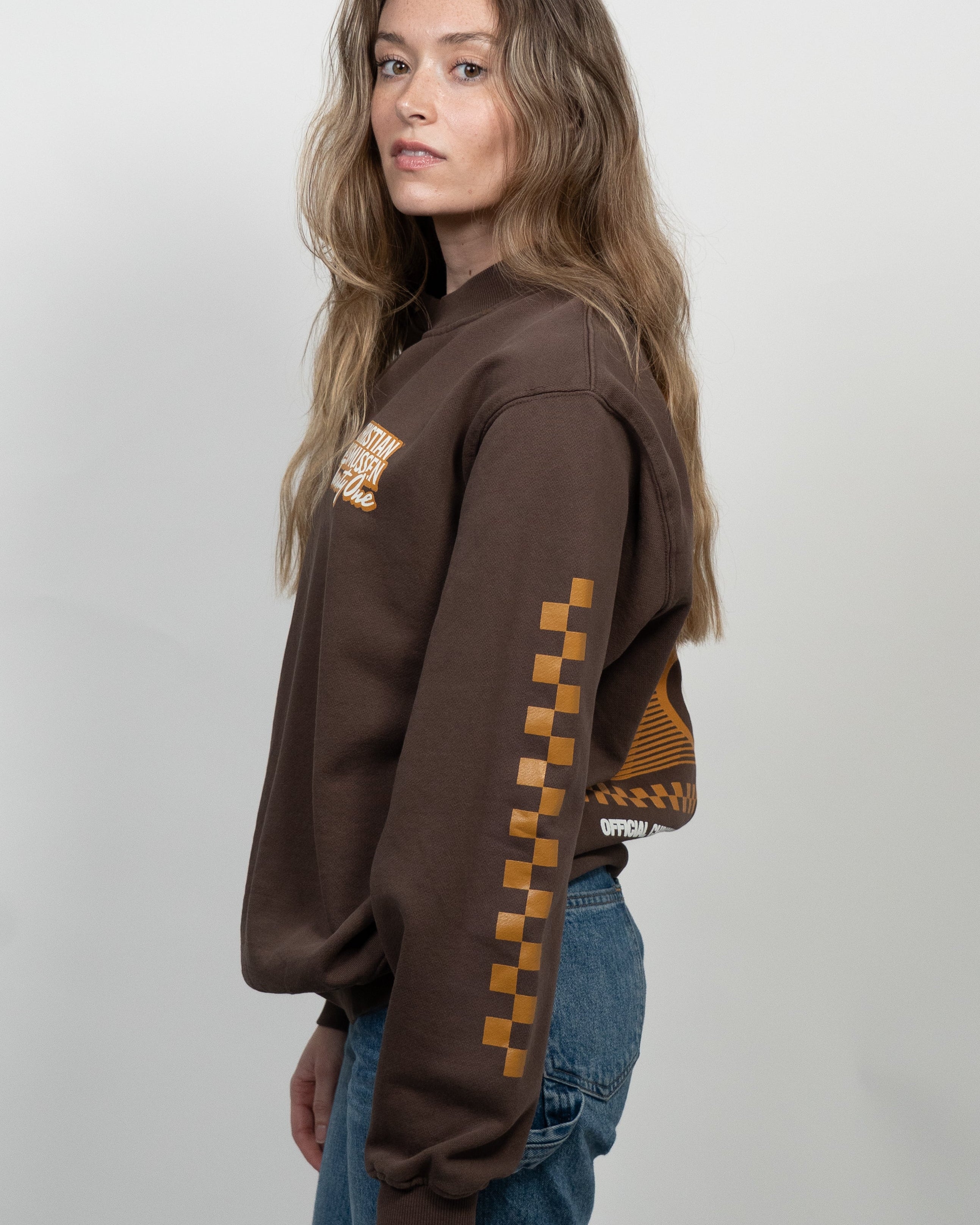 Person wearing a brown hoodie with checkered pattern on a white background