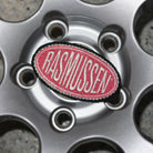 Close-up of a Rasmussen logo on a car wheel rim.